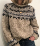 Cozy beige knit sweater with warm multicolor Nordic pattern.