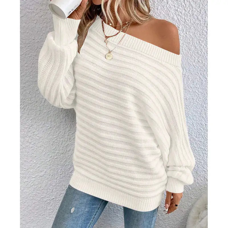 woman wearing a pink off-shoulder ribbed sweater styled with denim for a casual chic look